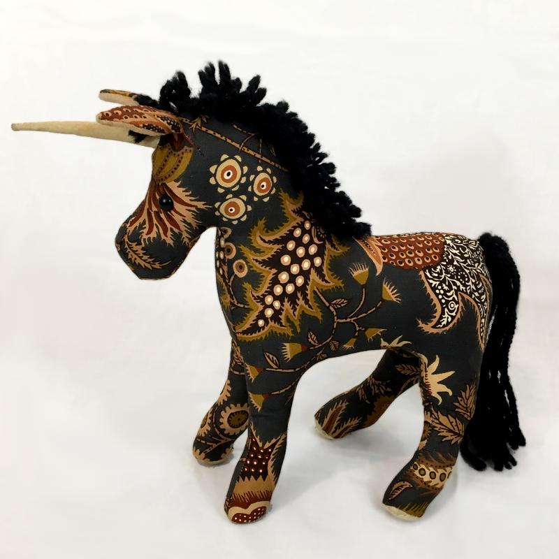 An original pattern of a unicorn handcrafted throughout created from 100% cotton print fabric with polyester fill toy-decorative accessory.