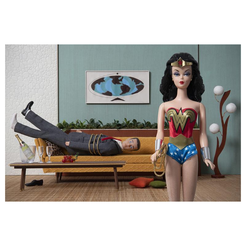 A photograph of Barbie as Wonder Woman utilizing her Lasso of Truth to subdue Ken