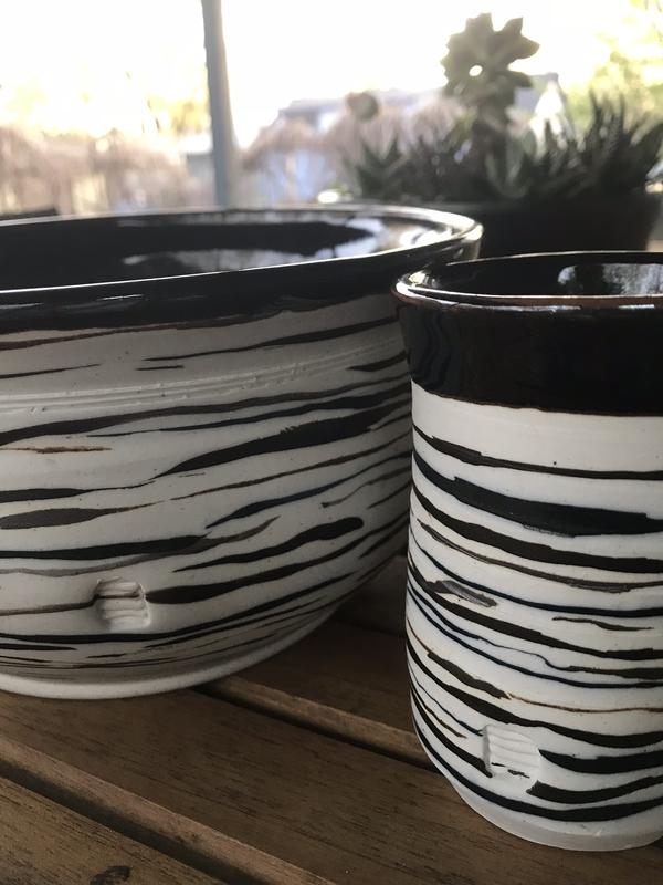 Two porcelain hand thrown bowls dialogue. Hand scribed glazed lines define shape, rhythm and story.