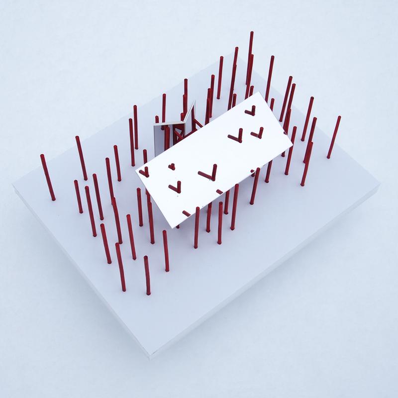 A scale model of an outdoor sculpture depicting a grove of red pillars and the sky reflected in a series of mirrors located within the field.
