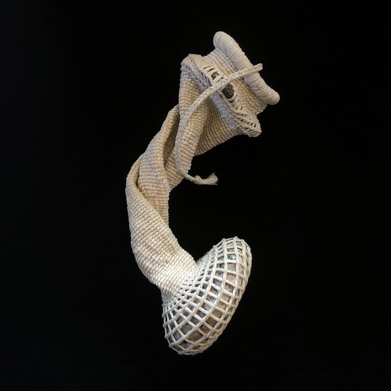 An off-white vessel made of waxed linen woven around stones.